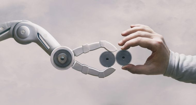 Resource Scheduling: How much Lab automation is Too Much? (Robot and human hands holding gears.)