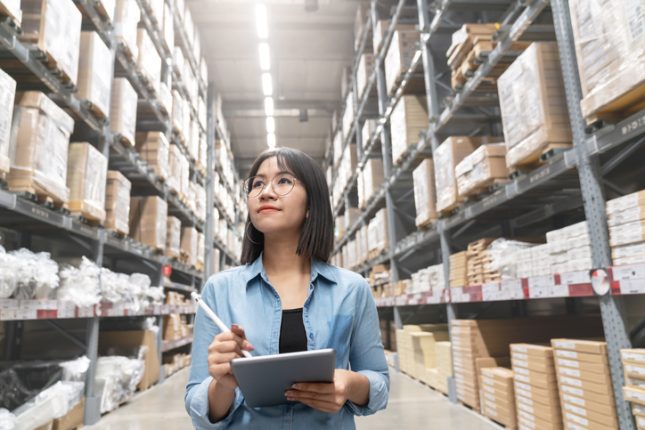 Woman checks inventory in a warehouse