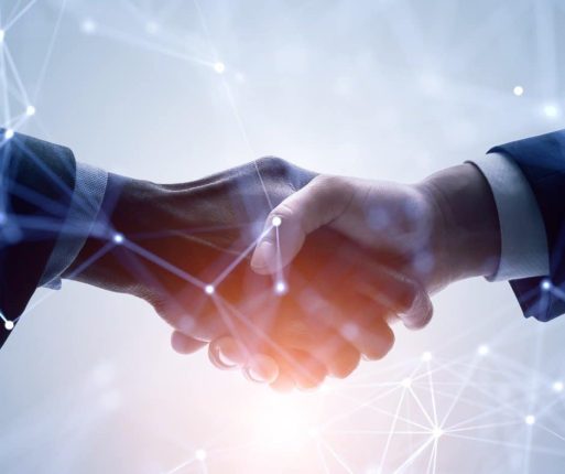 A stylized photo of two hands shaking over a business agreement, much like the agreement between Binocs and TrakCel